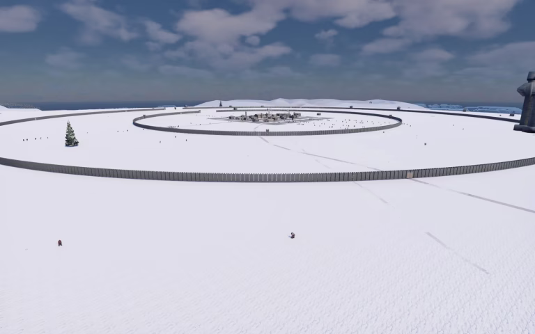 A wide snowy plain with two huge ring-shaped palisade walls, a small cluster of grey houses in the middle, a few tiny figures in the snow, and dark water on the horizon.