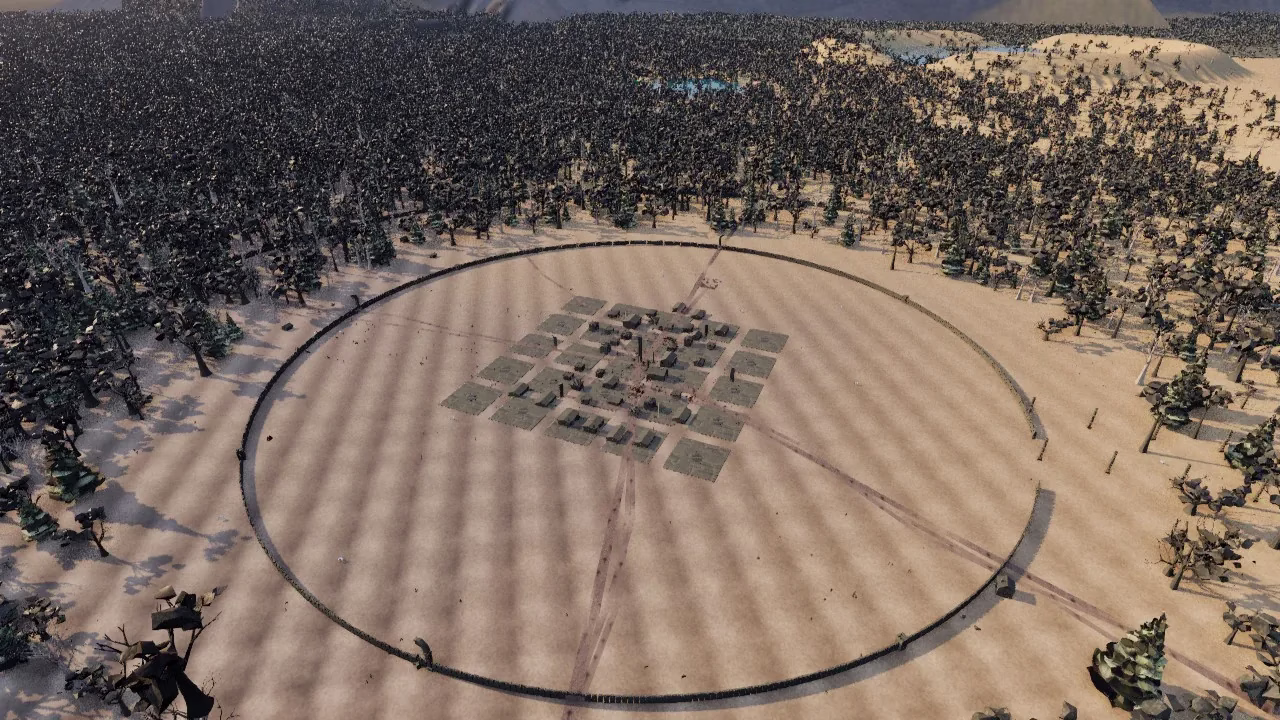 A town seen from high above inside a big round wall on sandy ground, its buildings sitting on a neat grid of square plots, with dense forest all around.