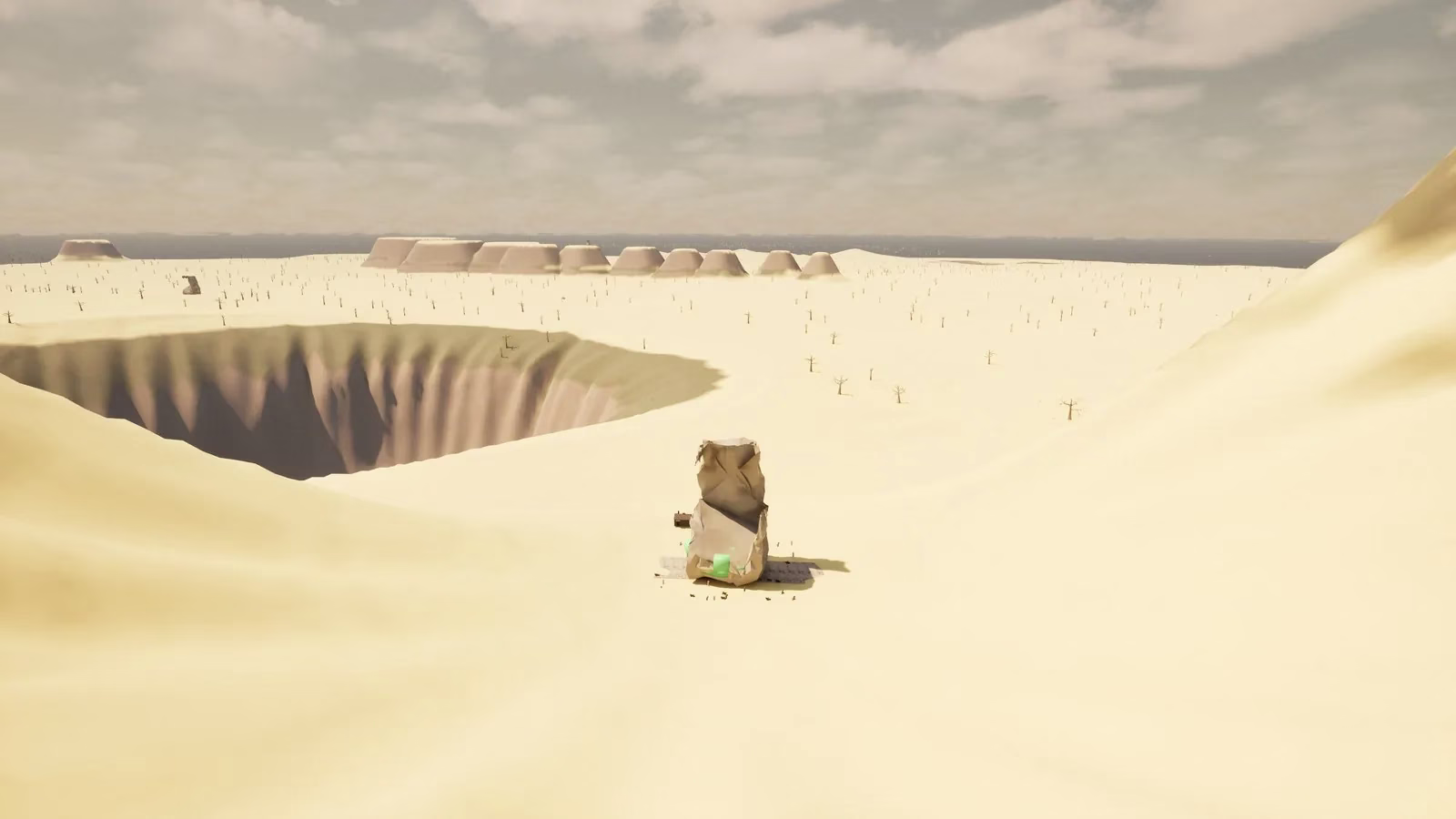A pale sand plain with a deep round sinkhole on the left, a row of flat-topped mesas and the sea on the horizon, and a large rock in the foreground.