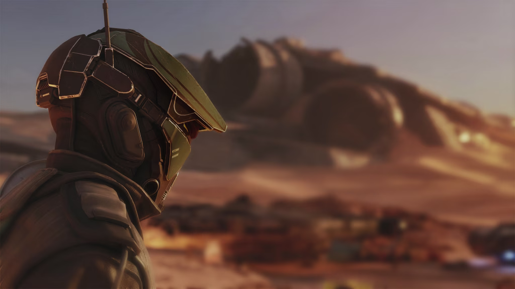 A racer in a weathered helmet looks out over a hazy orange desert.